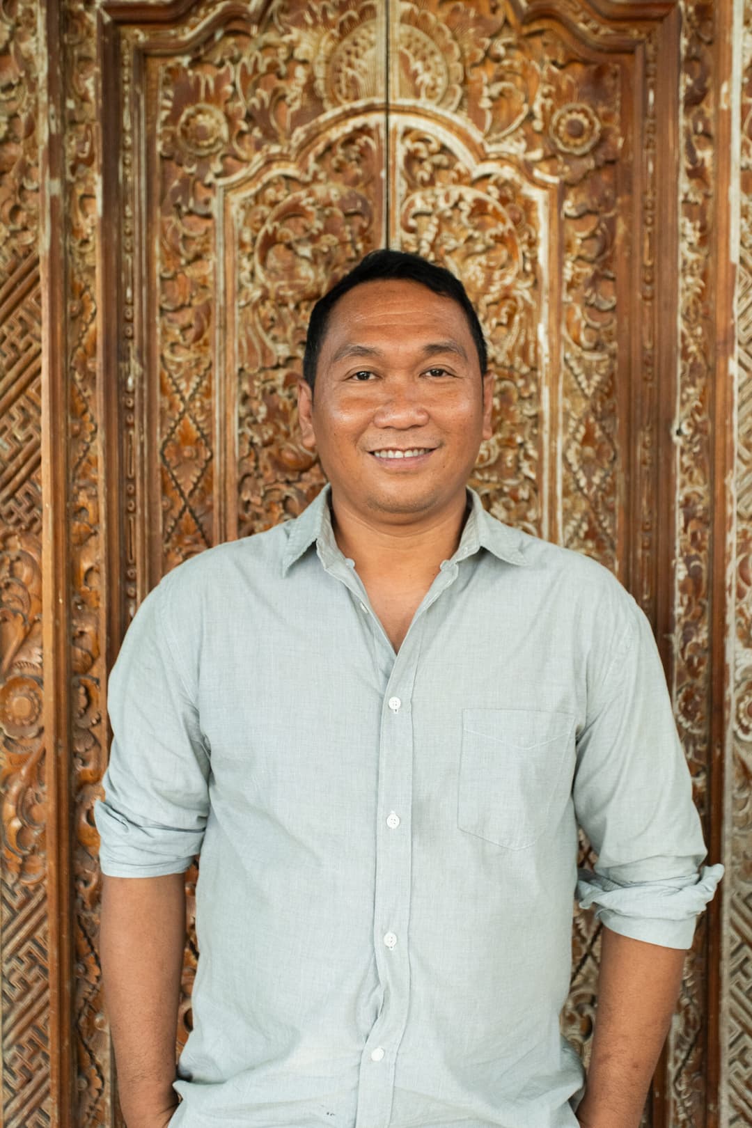 Ngurah Heru Wijaya, owner of Jero Farm, holding a free-range hen